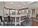 Kitchen featuring granite countertop peninsula and bar stools, stainless steel appliances and white cabinets at 208 Cottonwood Cir, Peachtree City, GA 30269