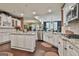 Open kitchen concept with an island, white cabinets, granite countertops, and stainless appliances at 208 Cottonwood Cir, Peachtree City, GA 30269