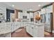 Bright open kitchen boasts an island, white cabinets, granite counters and stainless appliances at 208 Cottonwood Cir, Peachtree City, GA 30269