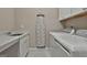 Modern laundry room featuring a white marble countertop, sink, washer, and dryer at 208 Cottonwood Cir, Peachtree City, GA 30269