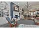 Open concept living room and kitchen with built-in bookshelves, fireplace and plenty of seating at 208 Cottonwood Cir, Peachtree City, GA 30269