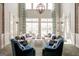 Inviting common area with large windows, comfortable seating, and a stylish chandelier at 208 Cottonwood Cir, Peachtree City, GA 30269