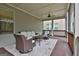 Inviting screened porch featuring wicker furniture and a ceiling fan for outdoor comfort at 208 Cottonwood Cir, Peachtree City, GA 30269
