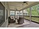Spacious screened porch with wicker furniture, ceiling fans, and scenic outdoor views at 208 Cottonwood Cir, Peachtree City, GA 30269