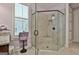 A glass shower with a built-in seat, tiled walls, and contemporary fixtures at 208 Cottonwood Cir, Peachtree City, GA 30269