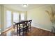Bright dining room with a bay window providing natural light, and hardwood floors at 701 Monticello Ln, Mcdonough, GA 30253