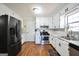 A well-equipped kitchen with white cabinets and modern stainless steel appliances at 701 Monticello Ln, Mcdonough, GA 30253