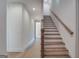 Hallway showcasing a wooden staircase with white risers and natural light flowing through the space at 185 Paislee Park (Lot #10 Paislee Park) Dr, Fayetteville, GA 30215