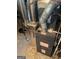 Image shows the property's furnace, including its ductwork, various pipes, and an electrical cord on the concrete floor at 8794 Homewood Dr, Riverdale, GA 30274