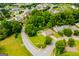 Aerial view of house surrounded by a neighborhood with mature trees and sidewalks at 101 Deer Park Dr, Carrollton, GA 30116