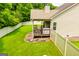 Expansive backyard featuring a covered deck area and well-maintained lawn, enclosed by a white privacy fence at 101 Deer Park Dr, Carrollton, GA 30116