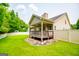 Well-maintained backyard featuring a covered back porch and white vinyl fence, offering a private outdoor retreat at 101 Deer Park Dr, Carrollton, GA 30116