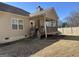 Backyard view showcasing a charming covered deck, wood steps, and a well-maintained lawn at 101 Deer Park Dr, Carrollton, GA 30116