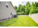 Lush backyard showcasing a well-kept lawn and white fencing, offering a private and serene outdoor space at 101 Deer Park Dr, Carrollton, GA 30116