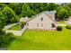 Aerial view of a home's backyard featuring a well-maintained lawn and a charming covered deck at 101 Deer Park Dr, Carrollton, GA 30116