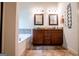 Bathroom featuring double vanity with granite countertops, framed mirrors, and bathtub at 101 Deer Park Dr, Carrollton, GA 30116