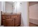 Bathroom featuring a granite-topped vanity with dark wood cabinets at 101 Deer Park Dr, Carrollton, GA 30116