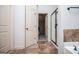 Bright bathroom entrance, transitioning to bedroom and shower with tiled floors and neutral tones at 101 Deer Park Dr, Carrollton, GA 30116