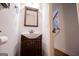 Cozy bathroom features a wooden vanity and mirror with an open view of the staircase at 101 Deer Park Dr, Carrollton, GA 30116