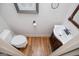 Compact half bathroom featuring a toilet, vanity and wooden floors at 101 Deer Park Dr, Carrollton, GA 30116