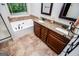 Bathroom featuring double vanity with granite countertops, framed mirrors, bathtub, and shower at 101 Deer Park Dr, Carrollton, GA 30116
