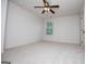 Spacious bedroom featuring neutral carpeting, paint, ceiling fan, and window providing natural light at 101 Deer Park Dr, Carrollton, GA 30116