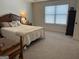 Bright bedroom featuring a bed, neutral carpet, and a traditional-style nightstand at 101 Deer Park Dr, Carrollton, GA 30116