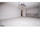 Spacious bonus room with neutral walls, carpet, ceiling fan, and railing at 101 Deer Park Dr, Carrollton, GA 30116