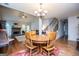 An open dining room with hardwood floors, a fireplace, and stairs leading to the upper level at 101 Deer Park Dr, Carrollton, GA 30116