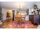 Dining room showing a wooden table with chairs and hardwood floors, adjoining kitchen at 101 Deer Park Dr, Carrollton, GA 30116