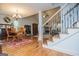 Dining room with wooden floors, a table and chairs, and view of a staircase and living room at 101 Deer Park Dr, Carrollton, GA 30116