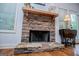 Stone fireplace with wooden mantle in open living area at 101 Deer Park Dr, Carrollton, GA 30116