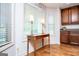 Well-lit kitchen with wooden cabinets and a decorative table with lamps near the window at 101 Deer Park Dr, Carrollton, GA 30116