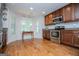 Open-concept kitchen with stainless steel appliances, wooden cabinets, and hardwood flooring at 101 Deer Park Dr, Carrollton, GA 30116