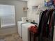 Functional laundry room with washer, dryer, and ample storage space on shelves at 101 Deer Park Dr, Carrollton, GA 30116