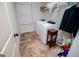 Cozy laundry room with washer, dryer, shelving, and tile floor at 101 Deer Park Dr, Carrollton, GA 30116
