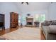 Living room featuring stone fireplace, ceiling fan, and hardwood floors at 101 Deer Park Dr, Carrollton, GA 30116