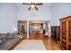 Open-concept living room with hardwood floors, high ceilings, and seamless transition to the kitchen and staircase at 101 Deer Park Dr, Carrollton, GA 30116