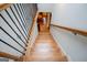 Staircase with hardwood steps and light carpet. The railing is wooden with black metal balusters at 101 Deer Park Dr, Carrollton, GA 30116