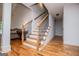 Staircase with hardwood steps, wood railing and ornate black metal balusters at 101 Deer Park Dr, Carrollton, GA 30116