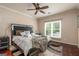 This primary bedroom features a ceiling fan, window, and large decorative mirror headboard at 675 Falls Lake Dr, Alpharetta, GA 30022