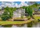 Beautiful waterfront home with a manicured lawn and stunning views at 675 Falls Lake Dr, Alpharetta, GA 30022