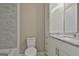 Bright bathroom featuring a modern vanity with marble countertop and tiled shower at 1967 Levgard Ln, Riverdale, GA 30296