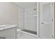 Modern bathroom with marble tiled shower and white tiled floor at 1967 Levgard Ln, Riverdale, GA 30296