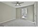 Bright bedroom featuring neutral carpet and large window looking out to the yard at 1967 Levgard Ln, Riverdale, GA 30296