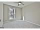 Neutral bedroom featuring carpet flooring, natural light from window, and ceiling fan at 1967 Levgard Ln, Riverdale, GA 30296
