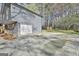 Spacious driveway and garage with attached side deck offers ample outdoor parking and access at 1967 Levgard Ln, Riverdale, GA 30296