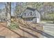 Attractive two-story home with gray siding, wooden deck, and lush landscaping at 1967 Levgard Ln, Riverdale, GA 30296