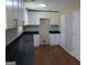 Updated kitchen featuring white cabinets, dark countertops, and stylish lighting at 1967 Levgard Ln, Riverdale, GA 30296