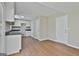Bright kitchen features white cabinetry, a black countertop, and wood-look flooring at 1967 Levgard Ln, Riverdale, GA 30296